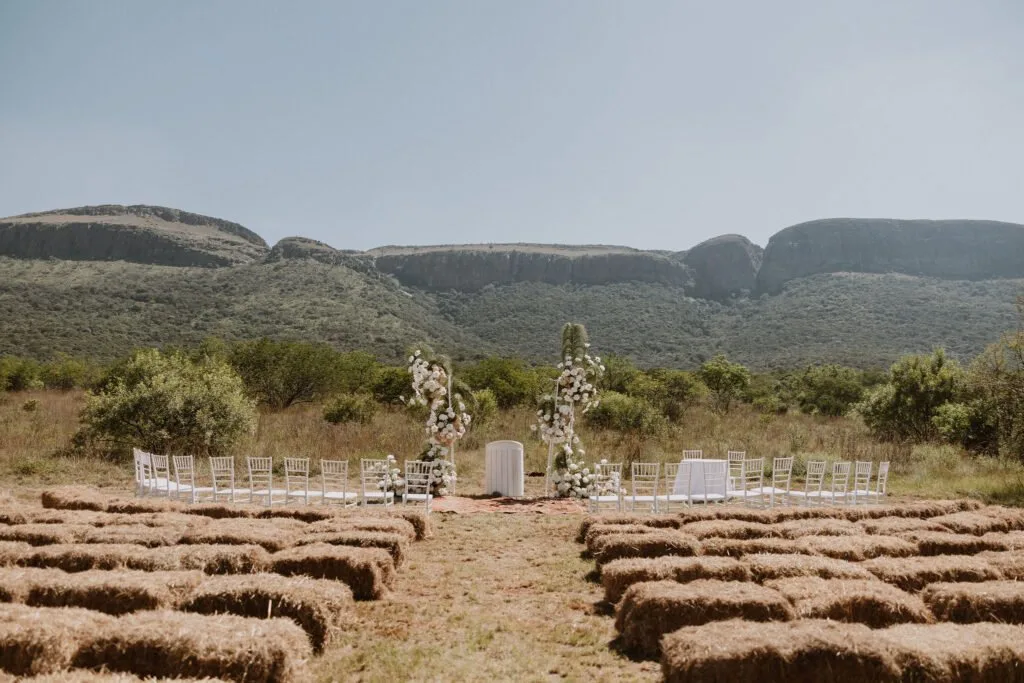 Open-air ceremony space with the Magaliesberg rising behind the aisle