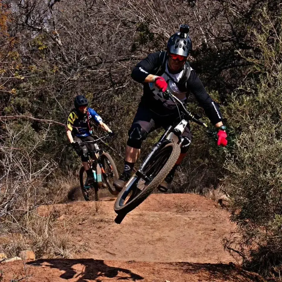 Two riders catching air on the Vergenoeg MTB trails