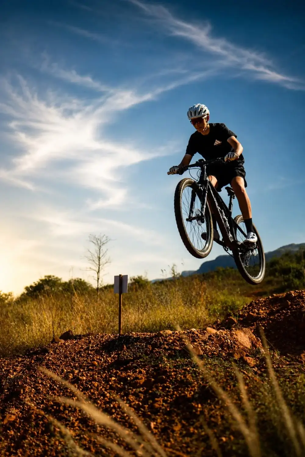 Rider airborne at golden hour on the Vergenoeg MTB trails